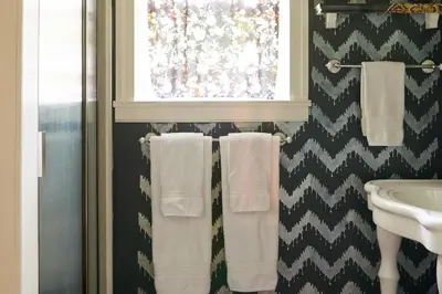 a bathroom with white towels and a window at Ulster County Farmhouse Near Waterfalls and Winery! in Pine Bush