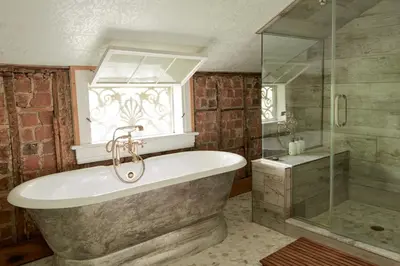 a bathroom with a tub and a glass shower at Ulster County Farmhouse Near Waterfalls and Winery! in Pine Bush