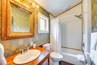 a bathroom with a sink and a toilet and a shower at Grill and Fire Pit Eclectic Ulster County Cabin in Pine Bush