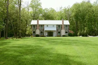 a large house with a large lawn in front of it at Grill and Fire Pit Eclectic Ulster County Cabin in Pine Bush