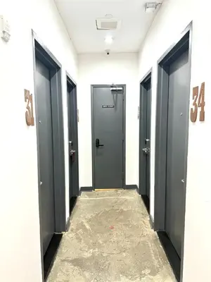a hallway with four doors in a building at Tribeca Hotel FiDi in New York