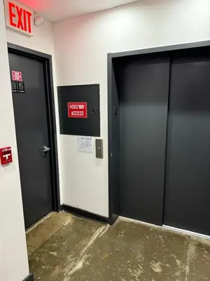 two exit doors in a building with a sign on it at Tribeca Hotel FiDi in New York