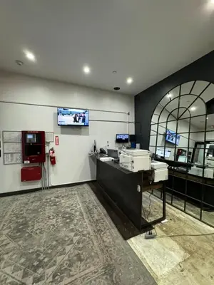 an office with a desk and a tv on the wall at Tribeca Hotel FiDi in New York