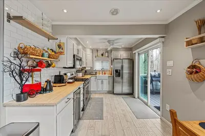 a kitchen with white cabinets and a counter top at Pocono Scandinavian Cottage cottage in Tobyhanna
