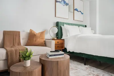 a bedroom with a bed and a couch at 73-310 Newly Reno Studio UWS Doorman Gym Laundry in New York