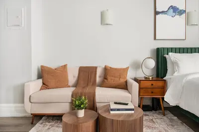 a living room with a couch and a bed at 73-310 Newly Reno Studio UWS Doorman Gym Laundry in New York