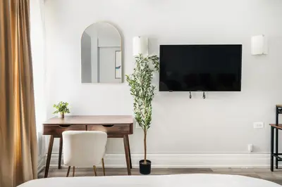a dining room with a table and a tv on a wall at 73-310 Newly Reno Studio UWS Doorman Gym Laundry in New York