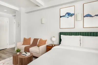 a bedroom with a bed and a couch at 73-310 Newly Reno Studio UWS Doorman Gym Laundry in New York