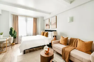 a hotel room with a bed and a couch at 73-304 Newly Reno Studio UWS Doorman Gym Laundry in New York