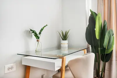 a glass table in a room with plants at 73-304 Newly Reno Studio UWS Doorman Gym Laundry in New York