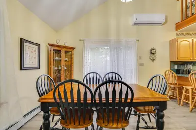 a dining room with a wooden table and chairs at Private Hot Tub Lakefront Poconos Home! in Pocono Summit