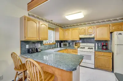 a kitchen with wooden cabinets and a counter top at Private Hot Tub Lakefront Poconos Home! in Pocono Summit