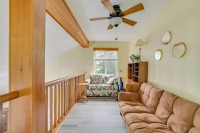 a living room with a couch and a ceiling fan at Private Hot Tub Lakefront Poconos Home! in Pocono Summit