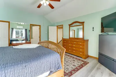 a bedroom with a bed and a dresser and a tv at Private Hot Tub Lakefront Poconos Home! in Pocono Summit