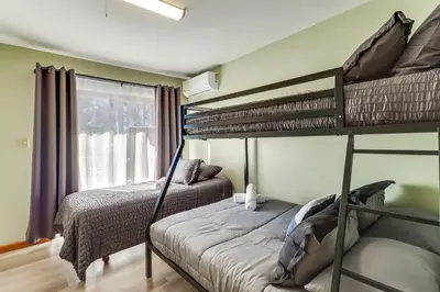 a bedroom with two bunk beds and a window at Private Hot Tub Lakefront Poconos Home! in Pocono Summit