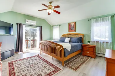 a bedroom with a bed and a ceiling fan at Private Hot Tub Lakefront Poconos Home! in Pocono Summit