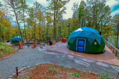 a campground with tents in the woods at Domes at Catskills in Swan Lake