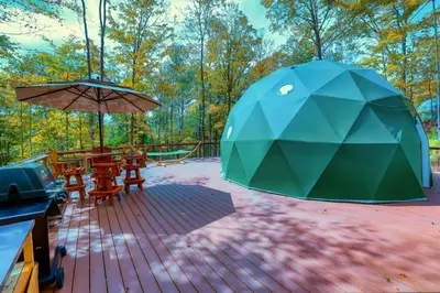 a tent and tables and chairs on a patio at Domes at Catskills in Swan Lake