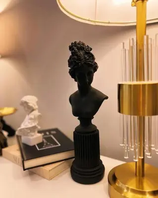 a statue of a bust on a table next to a lamp at Spacious & Stylish 2BR 2BA - Easy NYC Commute in Jersey City