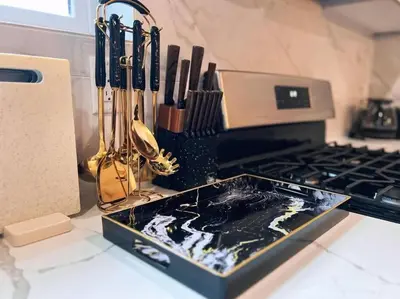 a kitchen counter with a tray of utensils on it at Spacious & Stylish 2BR 2BA - Easy NYC Commute in Jersey City