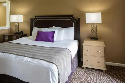 a hotel room with a large bed with a purple pillow at Smell the Chocolate from Hershey Park in this great resort 2BD vacation condo in Hershey