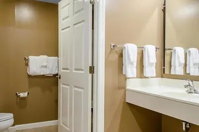 a bathroom with a sink and a toilet and a mirror at Smell the Chocolate from Hershey Park in this great resort 2BD vacation condo in Hershey