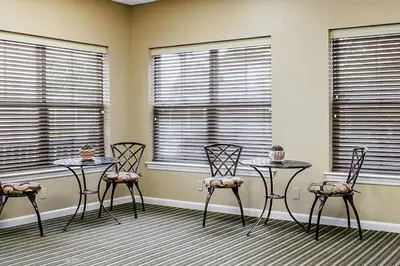 a room with three chairs and two tables and windows at Smell the Chocolate from Hershey Park in this great resort 2BD vacation condo in Hershey