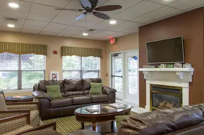 a living room with couches and a tv and a fireplace at Smell the Chocolate from Hershey Park in this great resort 2BD vacation condo in Hershey