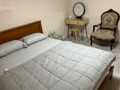 a bedroom with a bed and a chair and a desk at The Serene Retreat in Metuchen