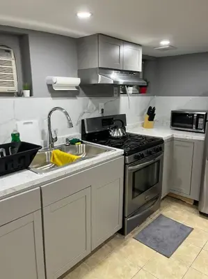 a kitchen with a sink and a stove top oven at 2 Bedroom Apartment By AirportS in Hillside