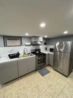 a kitchen with a stainless steel refrigerator and sink at 2 Bedroom Apartment By AirportS in Hillside