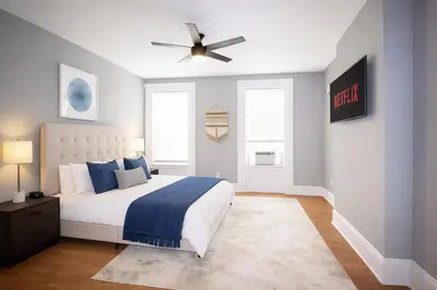 a bedroom with a bed and a ceiling fan at Hoboken 15 Min Train to Manhattan Full Kitchen in Hoboken