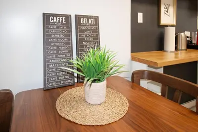 a table with a potted plant on top of it at Hoboken 15 Min Train to Manhattan Full Kitchen in Hoboken