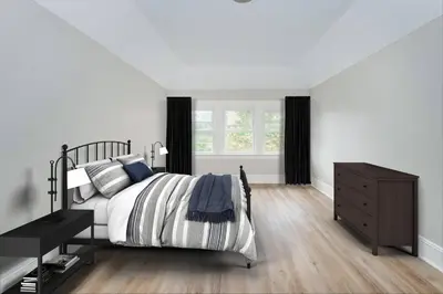 a bedroom with a bed and a dresser and a window at Perfect Private Unit in Passaic in Passaic