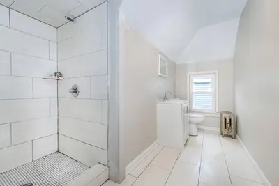 a white bathroom with a shower and a toilet at Perfect Private Unit in Passaic in Passaic
