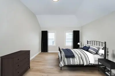 a white bedroom with a bed and a dresser at Perfect Private Unit in Passaic in Passaic