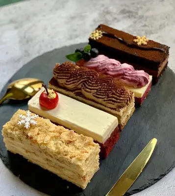 a plate with four different types of cakes on it at That Gray House Romantic getaway in Albrightsville