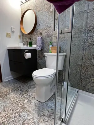 a bathroom with a toilet and a sink and a shower at That Gray House Romantic getaway in Albrightsville