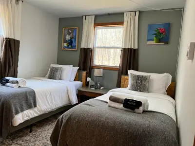 a bedroom with two beds and a window at That Gray House Romantic getaway in Albrightsville