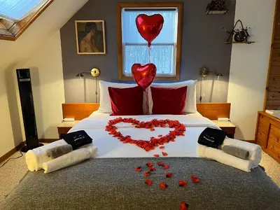 a bed with a heart made out of red heart balloons at That Gray House Romantic getaway in Albrightsville