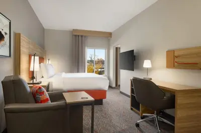 a hotel room with a bed and a desk at Candlewood Suites Lawrenceville - Princeton by IHG in Lawrenceville