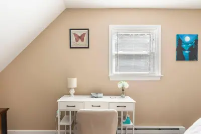 a bedroom with a desk and a chair and a window at The Beautiful & Cozy Malvec Chalet in Tobyhanna