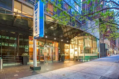 a building with a sign in front of it at Beautiful Resort in Midtown 45 - Deluxe 1BD in New York