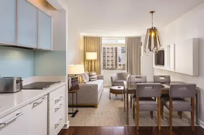a kitchen and living room with a couch and a table at Beautiful Resort in Midtown 45 - Deluxe 1BD in New York