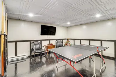 a ping pong table in a room with a tv at 7 Mi to Big Boulder Resort-Style Poconos Retreat in Albrightsville