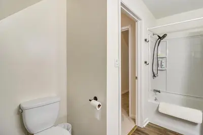 a white bathroom with a toilet and a shower at 7 Mi to Big Boulder Resort-Style Poconos Retreat in Albrightsville