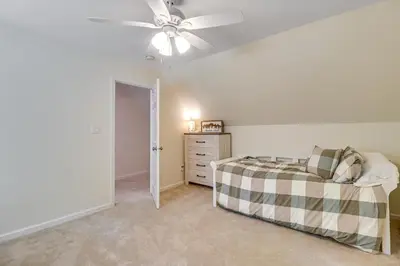 a bedroom with a bed and a ceiling fan at 7 Mi to Big Boulder Resort-Style Poconos Retreat in Albrightsville