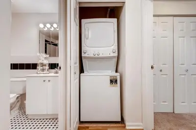 a washer and dryer in a white room at Global Luxury Suites at Hoboken Waterfront in Hoboken