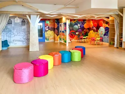 a room with colorful stools in a room with a balloon wall at Global Luxury Suites at Hoboken Waterfront in Hoboken