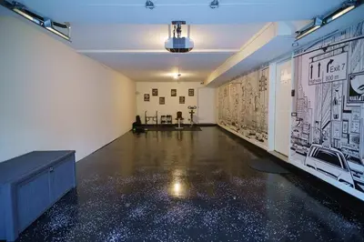 an empty room with posters on the walls at Newark Gem Ruby 3BR, 3BA - Sleeps 14 - Walk to Prudential Center and Newark Penn Station, Near EWR and American Dream Mall, includes Parking - WiFi - Laundry - Backyard - Gym in Newark